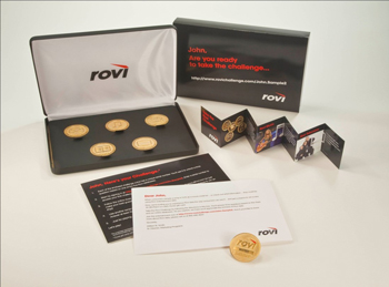 Picture of Rovi tele-prospecting incentive game collateral with coins, brochures and container.