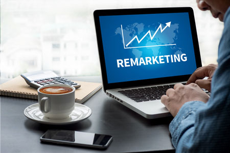 Remarketing Training results in a chart on a laptop screen showing positive ROI growth.
