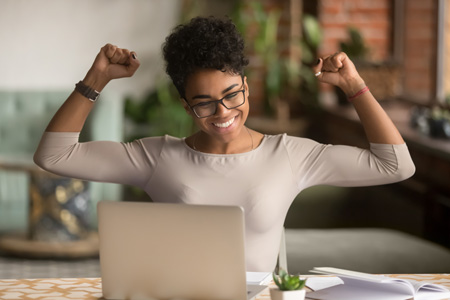 African American woman rejoicing over email marketing win.