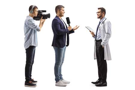 Cameraman with reporter interviewing a doctor.