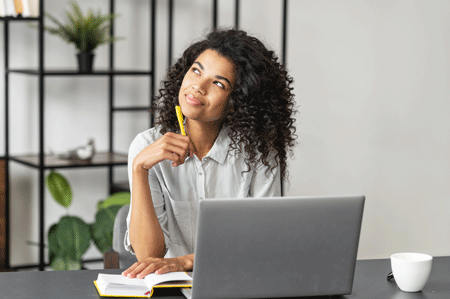 Woman at desk with laptop.